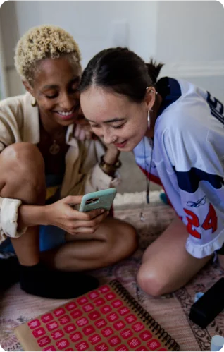 women on workshop looking at phone